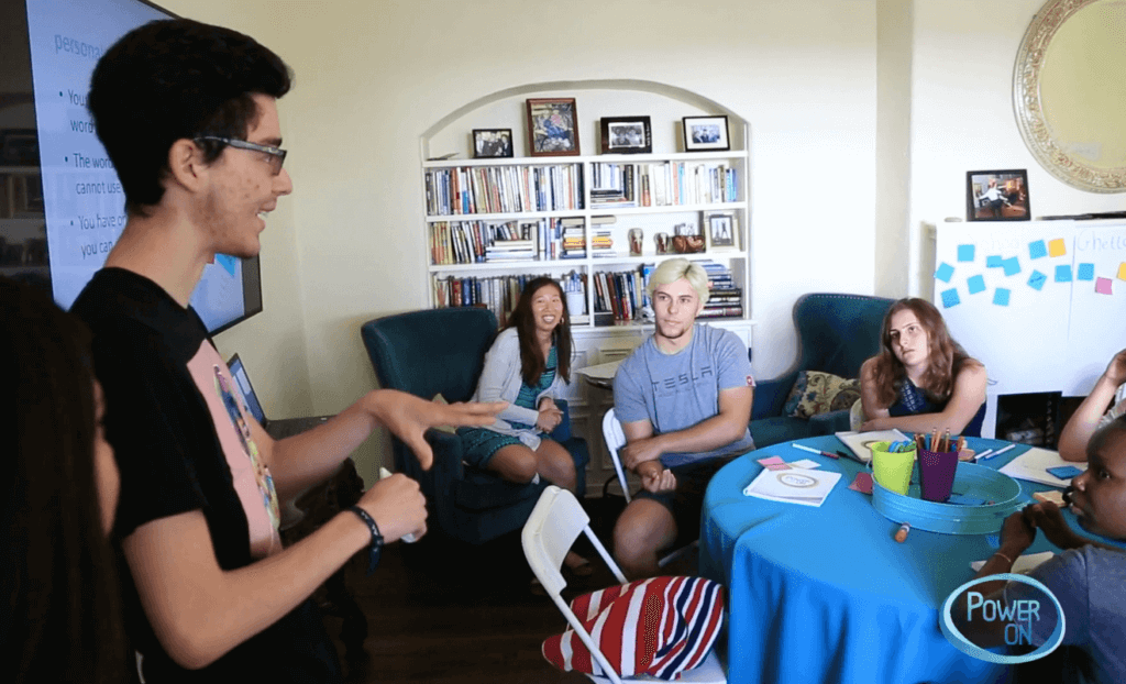 A group of teens discussing something between them